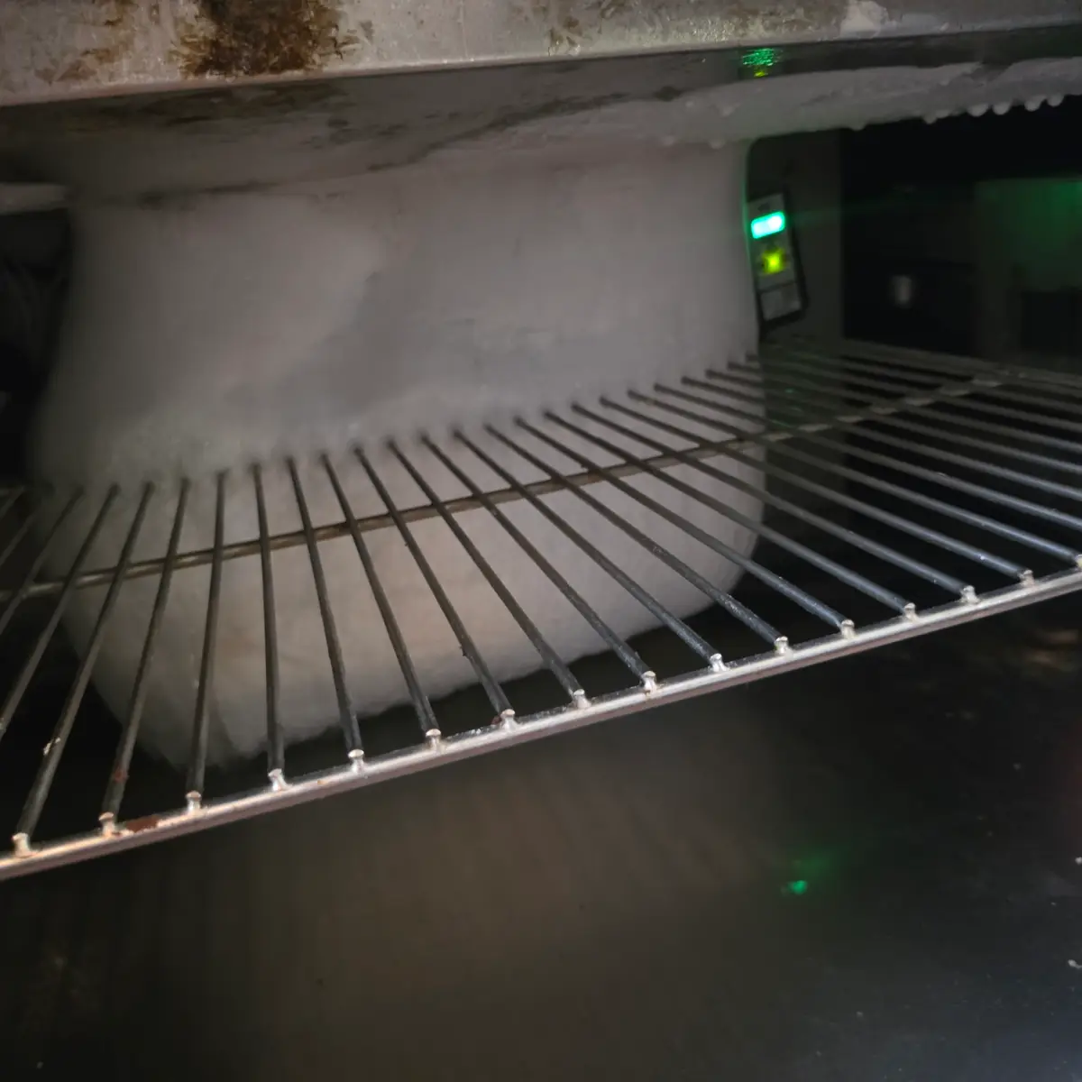 Severely frozen evaporator and blocked airflow inside a commercial restaurant prep table
